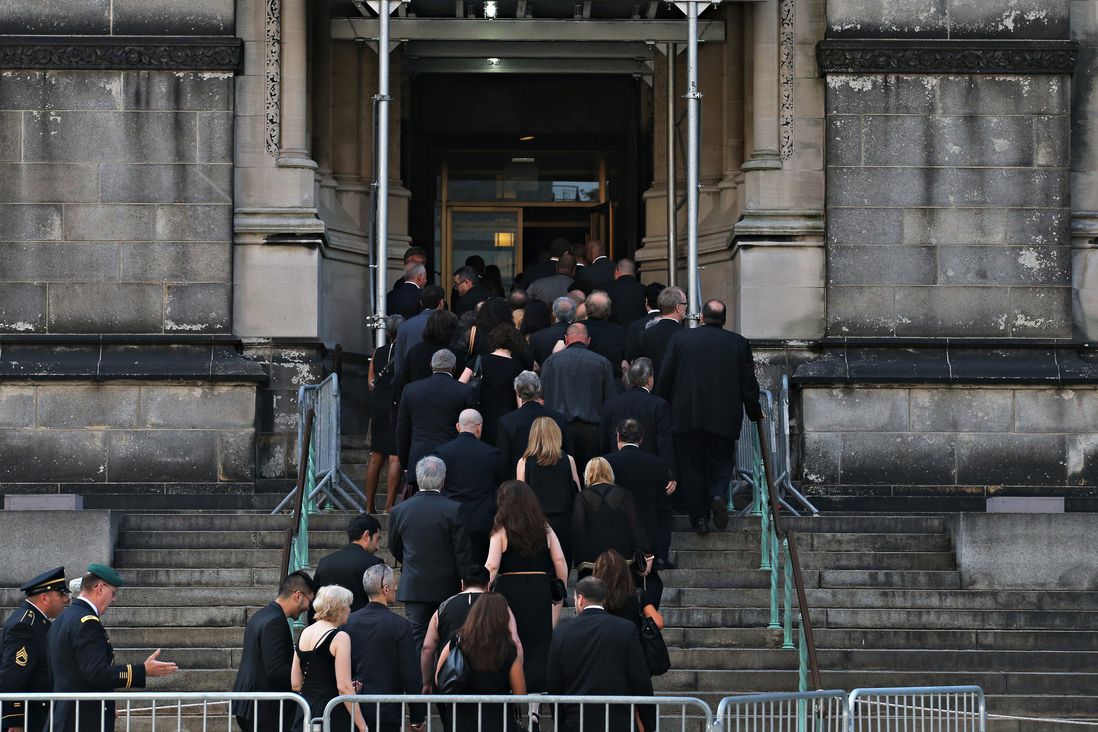 Mourners go into the church